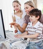 Happy mother and her children using a computer