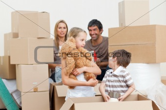 Family unpacking boxes after move in 