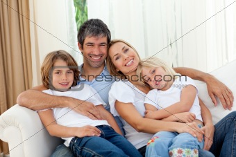 Smiling family relaxing on the sofa