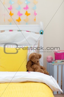 Child's bedroom with a teddy bear on the bed