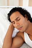 Attractive man sleeping on the bed