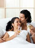 Man kissing his wife and drinking Champagne