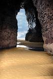 inside golden sandy beach cliff cave