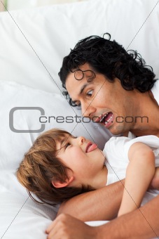Cheerful father having fun with his son