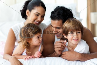 Animated family having fun lying on bed