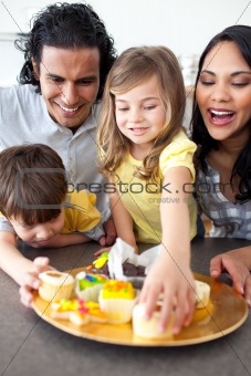 Jolly family eating cookies