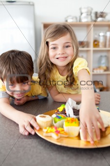 Brother and sister eating cookies