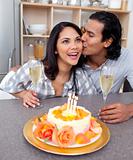 Enamoured couple celebrating in the kitchen