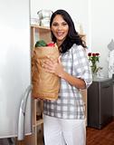 Brunette woman unpacking grocery bag 