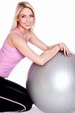 Young woman exercising on fitness ball