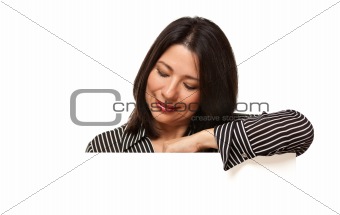 Attractive Multiethnic Woman Looking Down to Blank White Sign Isolated on a White Background.