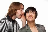Attractive Diverse Couple Whispering Secrets Isolated on a White Background.