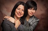 Attractive Multiethnic Mother and Daughter Studio Portrait on a Muslin Background.