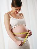 pregnant woman with measuring tape