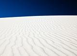 Sand dune with bright blue sky