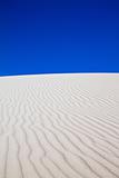 Sand dune with bright blue sky