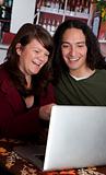 Couple with laptop laughing