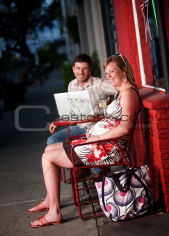 Happy couple sitting outside