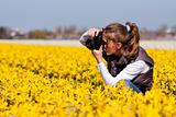 Girl making pictures of flowers