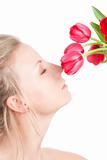 Woman smells bunch of flowers