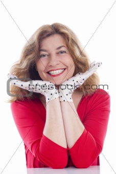 portrait of a middle-aged woman in red with polka-dot gloves - isolated on white