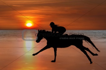 silhouette of a horse and rider galloping on beach