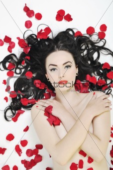 beautiful young nude woman with roses isolated on white