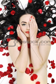 beautiful young nude woman with roses isolated on white