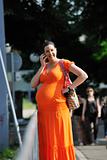 happy pregnant woman talking by cellphone