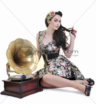 pretty girl listening music on old gramophone