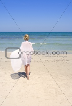 woman on the beach with a white sarong