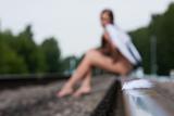 young woman sitting on the rails