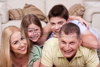 Smiling family lying together on the floor