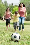 Family playing soccer and having fun