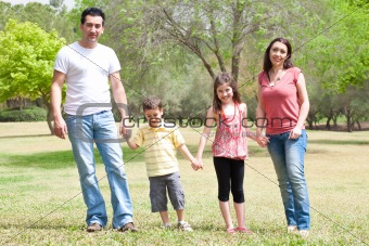 Family posing to camera in the park