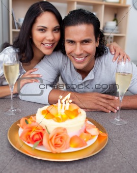 Cheerful man and his wife celebrating his birthday in the kitchen