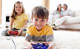 Cute little boy playing video game with his sister 