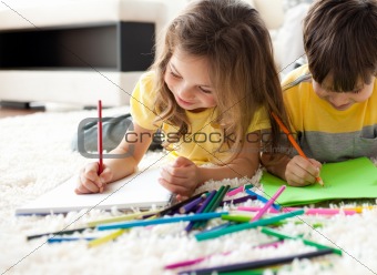 Close-up of children drawing lying on the floor 