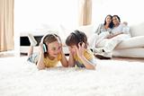 Brother and sister listening music with headphones 