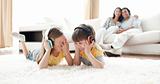 Laughing children listening music with headphones 