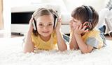 Children playing on the floor with headphones