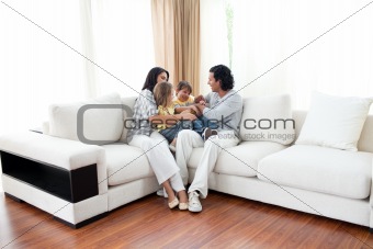Animated family having fun sitting on sofa