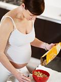 pregnant woman doing breakfast at home