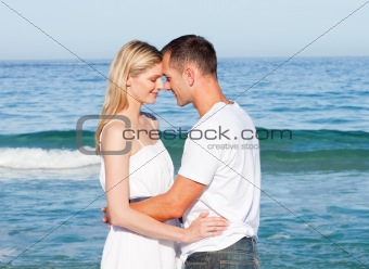 Intimate lovers embracing at the beach