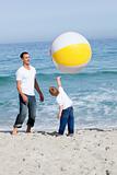Happy father and his son playing with a ball 