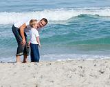 Young father and son playing on a beach