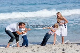 Cheerful family playing tug of war