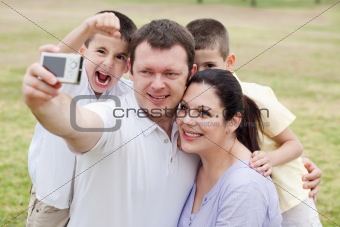 Happy family pilled together and taking self portrait 