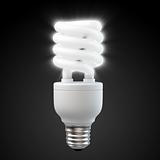 White energy saving light bulb on black