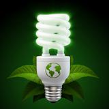 White energy saving light bulb with leafs on black